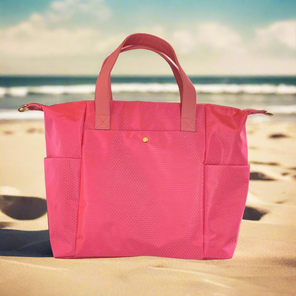 Pink tote bag with brown handles on a gray background